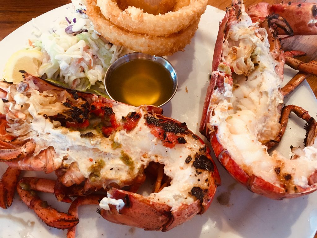 Very fresh grilled lobster cut in half and served with coleslaw and onion rings
